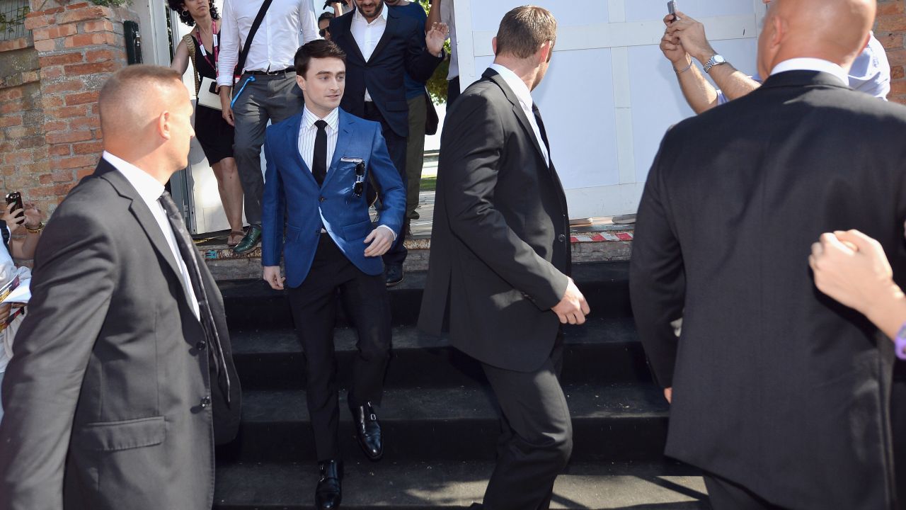 Daniel Radcliffe is escorted to the festival on September 1.