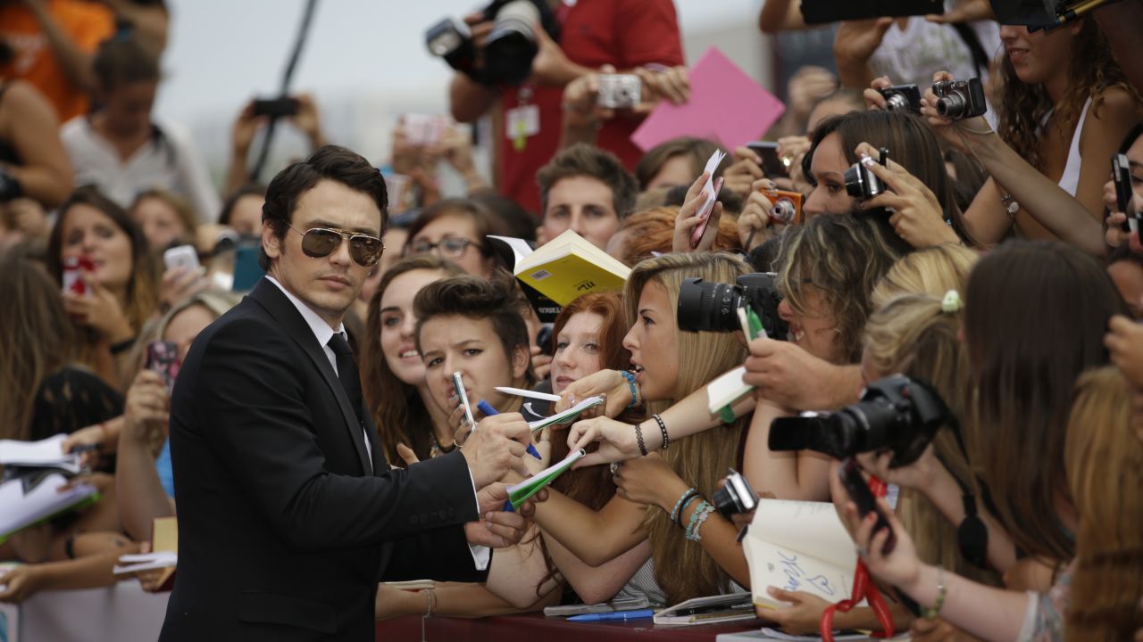 James Franco signs autographs as he arrives for the film "Palo Alto."