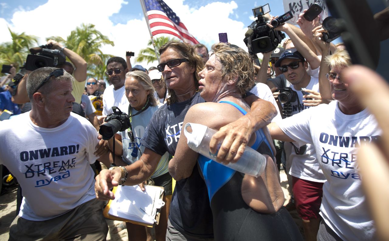 Nyad and her trainer Bonnie Stoll hug as Nyad walks ashore on September 2.