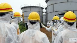 Japan's nuclear watchdog members, including Nuclear Regulation Authority members in radiation protection suits, inspect contaminated water tanks at the Tokyo Electric Power Co (TEPCO) Fukushima Dai-ichi nuclear power plant in the town of Okuma, Fukushima prefecture on August 23, 2013. Japan's nuclear watchdog dispatched an inspection team to the crippled Fukushima plant after workers found a huge toxic water leak and unexplained radiation hotspots. Earlier this week around 300 tonnes of radioactive liquid is believed to have escaped from one of the hundreds of tanks that hold polluted water, some of which was used to cool the broken reactors, in an episode dubbed the most serious in nearly two years. JAPAN OUT AFP PHOTO / JAPAN POOL via JIJI PRESS (Photo credit should read JAPAN POOL/AFP/Getty Images) 