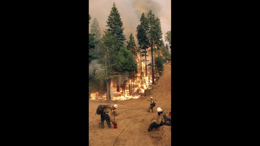 BLM Silver State Hotshot crew members perform burn operations on the southern flank of the fire on August 30.