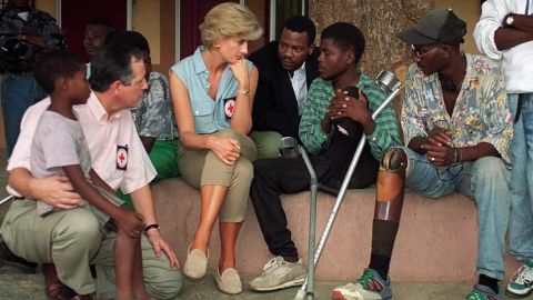 Princess Diana speaks with amputees who were victims of land mines at Neves Bendinha Orthopedic Workshop in Luanda, Angola, on January 14, 1997.