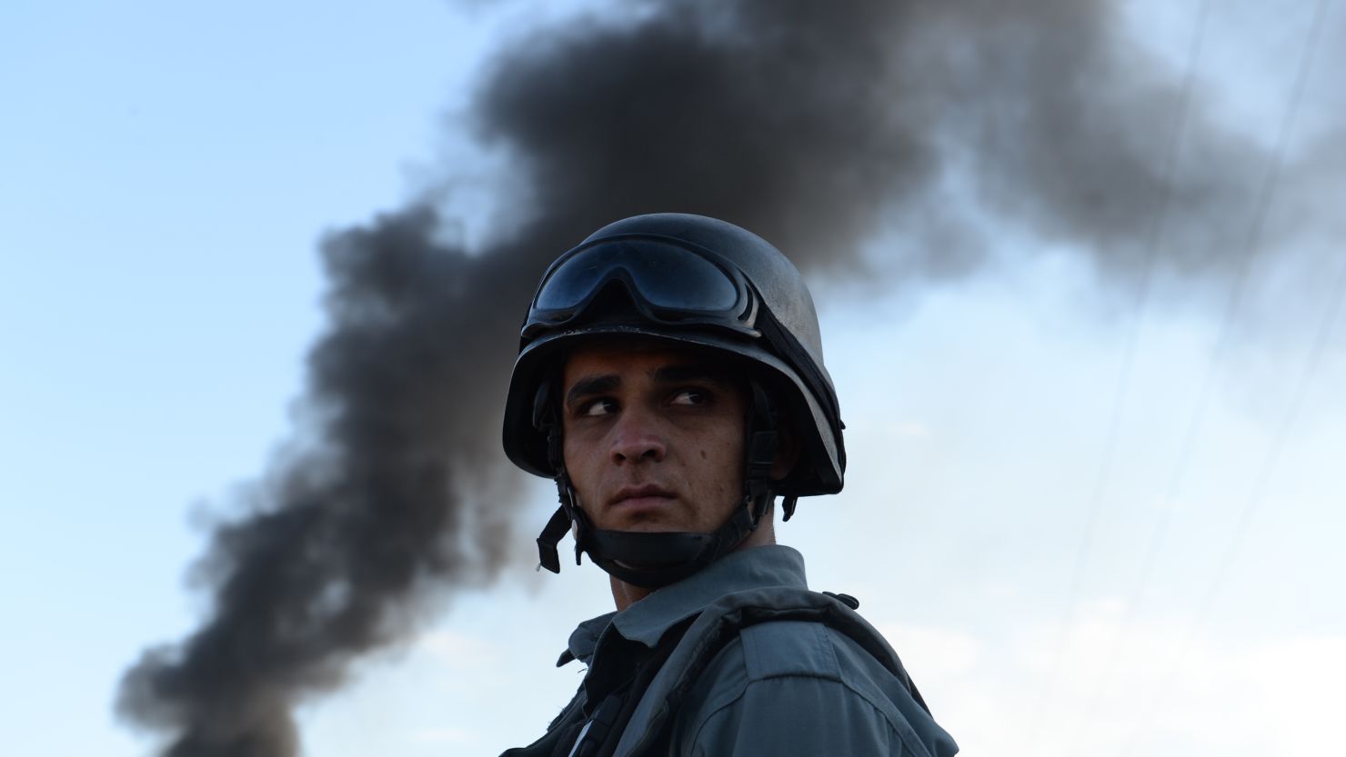 (File) Afghan policeman stand guard at the site of a suicide attack in Kabul on July 2, 2013.