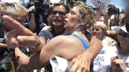 Endurance swimmer Diana Nyad, right, and her trainer, Bonnie Stoll hug after Nyad walks ashore Monday, Sept. 2, 2013 in Key West, Fla. after swimming from Cuba. Nyad became the first person to swim from Cuba to Florida without the help of a shark cage. She arrived at the beach just before 2 p.m. EDT, about 53 hours after she began her swim in Havana on Saturday. (AP Photo/J Pat Carter)