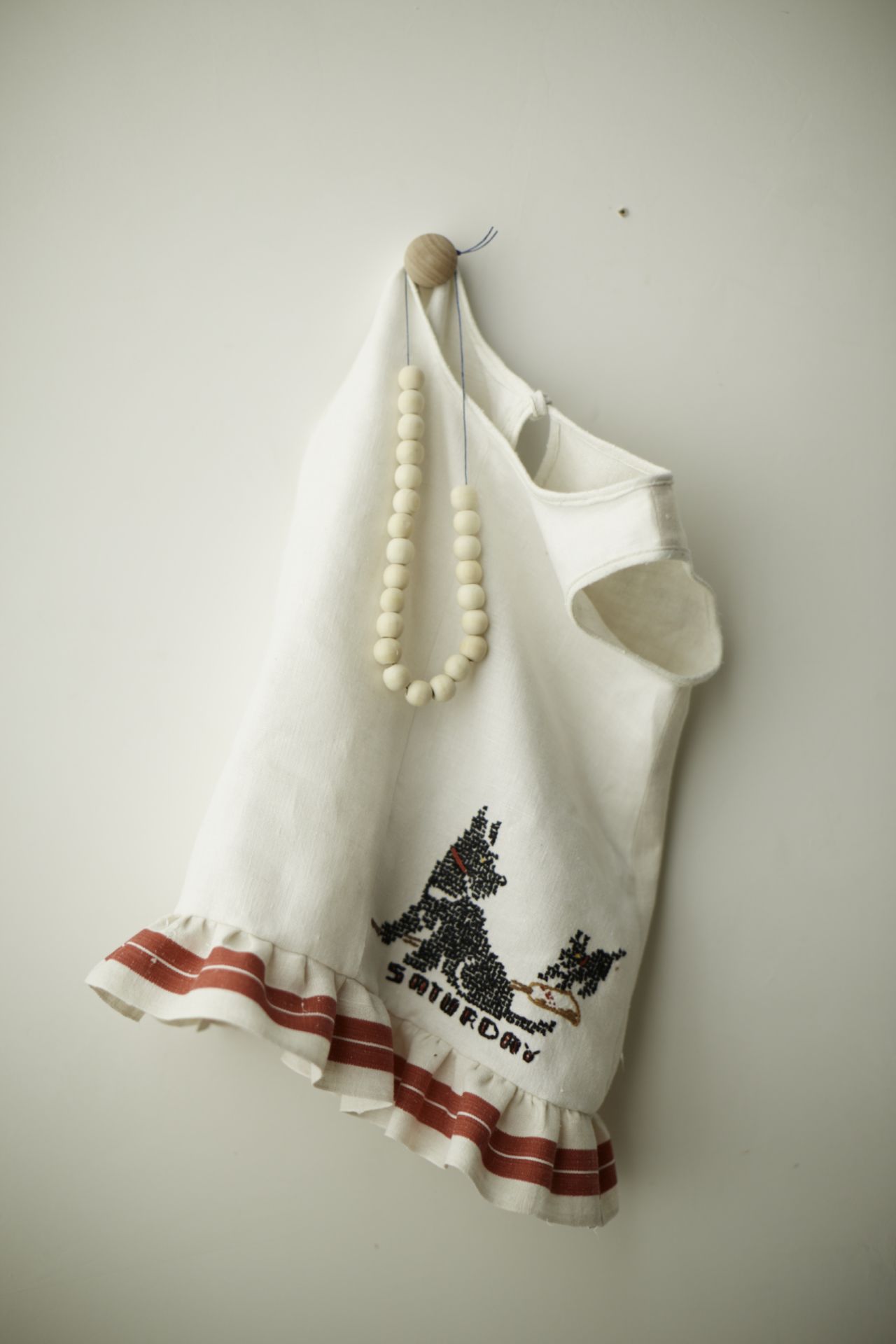 A variation on the tunic (made to highlight the towel's cross-stitch pattern) has a gathered ruffle at the hem.