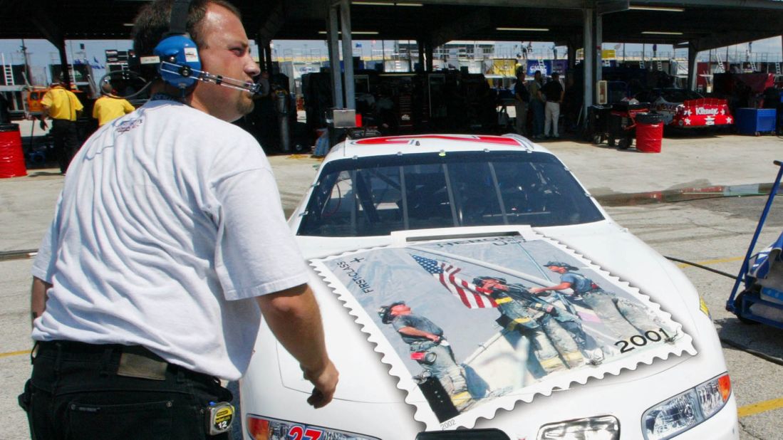NASCAR driver Jamie McMurray decorated the hood of his car with a replica of the "Heroes of 2001" stamp. A crew member helps ready the car at the Daytona International Speedway in 2002.