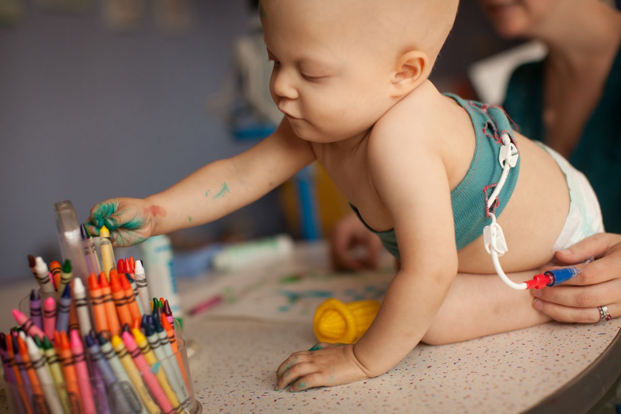 One night Kezia went home, dug out her sewing machine, grabbed some cotton knit fabric and created a sleeve that would hopefully secure Saoirse's PICC line comfortably. A few weeks later, when a doctor inserted a central chest line, Kezia created a chest wrap for the toddler.