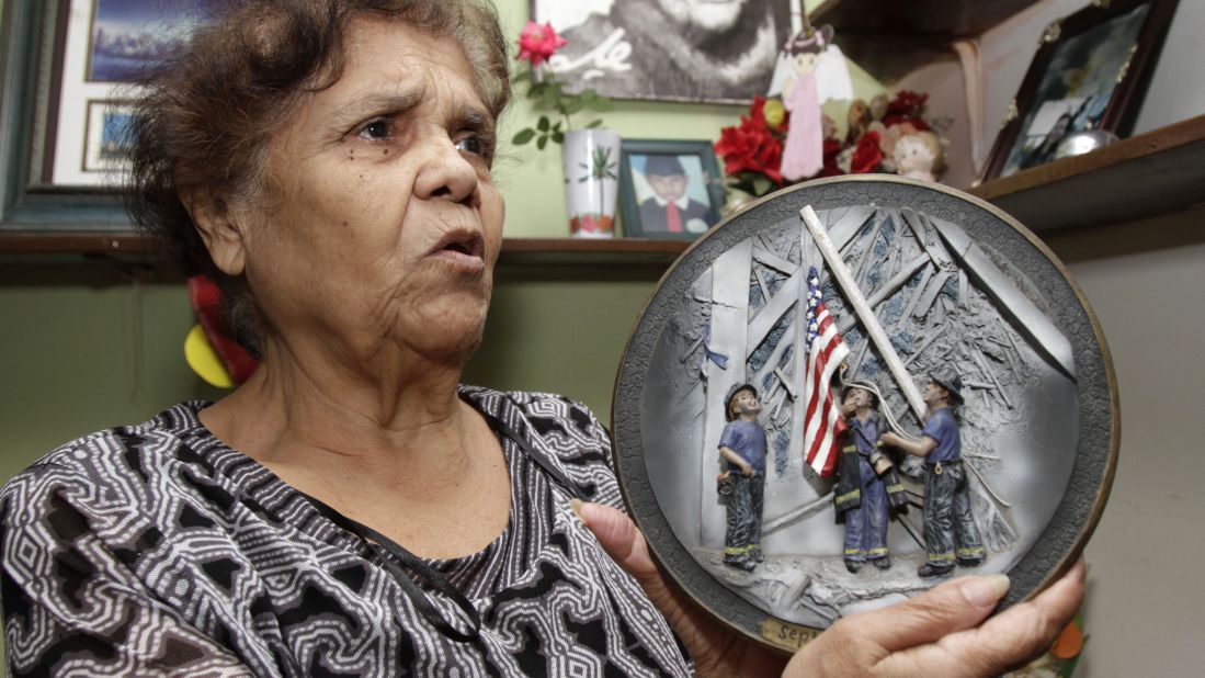 A woman holds a commemorative plate at her home in San Salvador, El Salvador, on September 7, 2011.