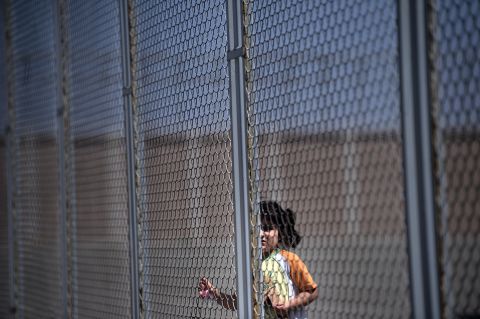 A Syrian girl stands behind a fence at Bulgaria's shelter near Lyubimets in August 2013.