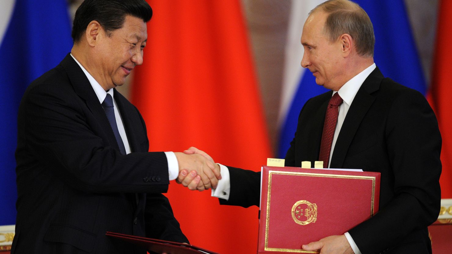 Russia's President Vladimir Putin (R) shakes hands with his Chinese counterpart Xi Jinping in Moscow, on March 22, 2013.