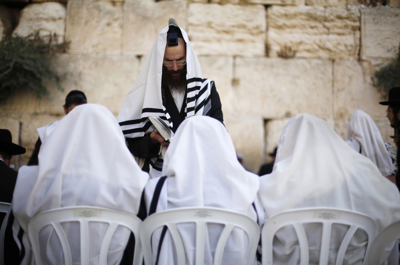 Covered in prayer shawls, Jewish worshipers gather at the Western Wall on September 4.