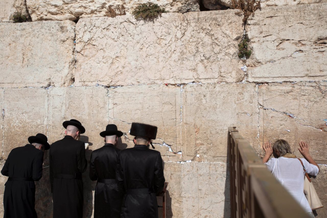 Men and women pray on opposite sides of a separation fence at the Western Wall on September 4.