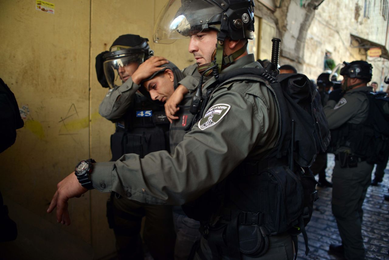 Israeli police officers detain a Palestinian man during clashes ahead of Rosh Hashanah in Jerusalem's Old City on September 4. Police said hundreds of demonstrators tried to block a group of visitors from reaching a hilltop compound known to Muslims as Noble Sanctuary and to Jews as Temple Mount. Some of the protesters were arrested after allegedly throwing stones at visitors.