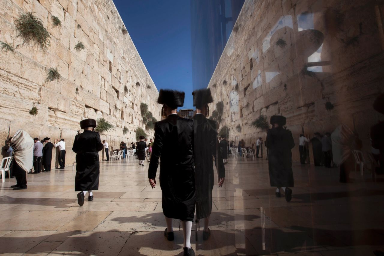 Orthodox Jewish men walk along the Western Wall on September 4. 