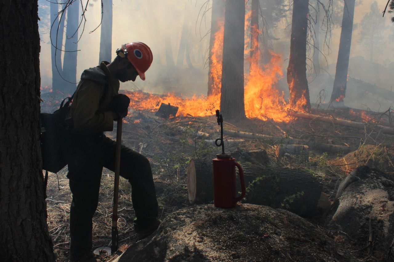 A Hotshot crew member rests near a controlled burn at Horseshoe Meadows as crews continue to fight the Rim Fire near Yosemite National Park in California on Wednesday, September 4. The massive wildfire has burned over 280,000 acres and is now 80% contained, according to a state fire spokesman.