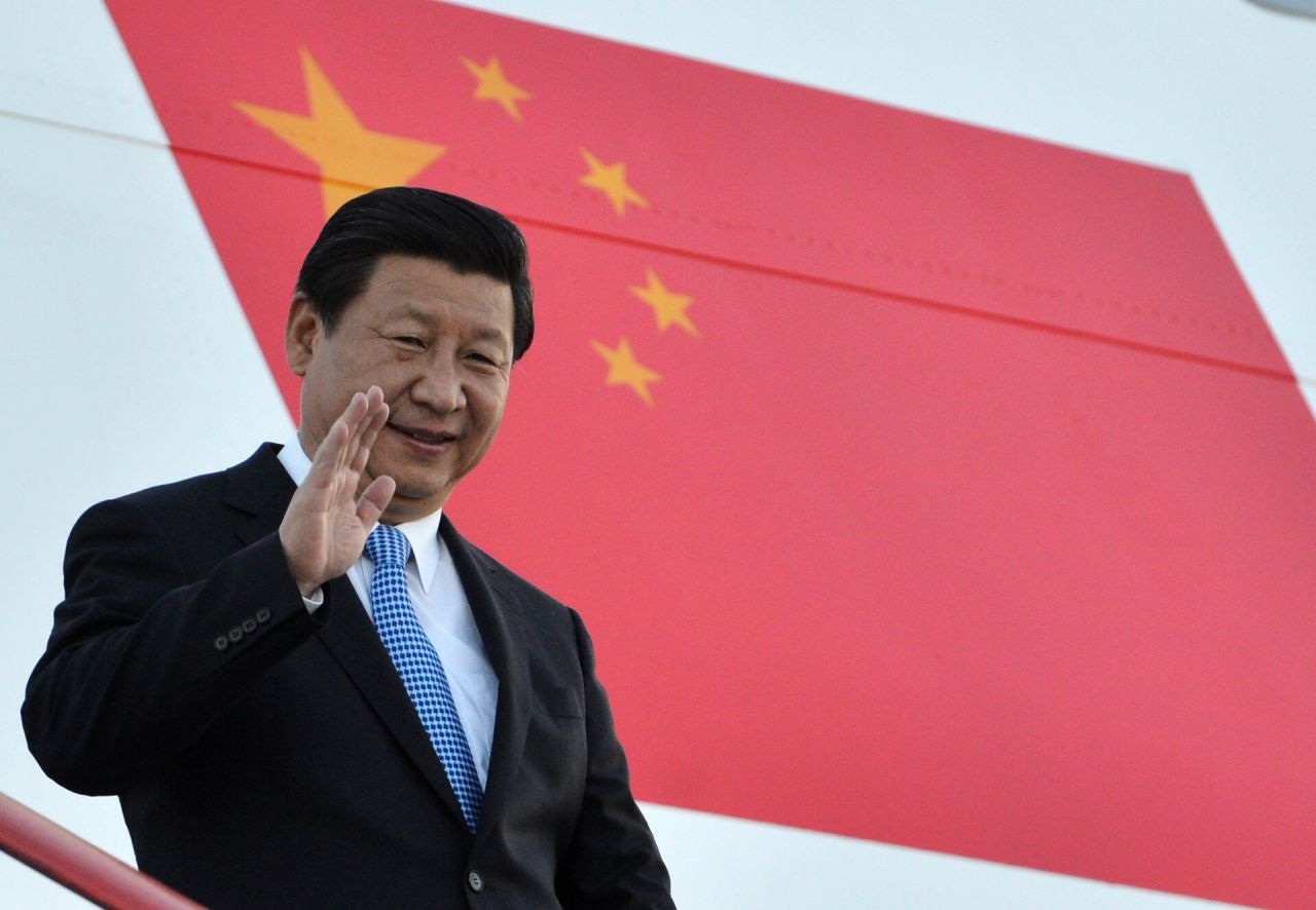 China's President Xi Jinping waves as he arrives in St. Petersburg on Wednesday, September 4.