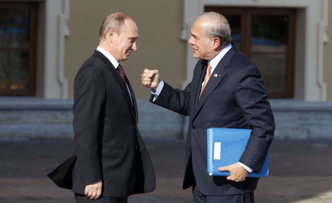José Ángel Gurría, right, secretary-general of the Organisation for Economic Co-operation and Development, gestures while speaking with Putin during arrivals for the G-20 summit.