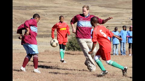 Prince William plays soccer during a visit to a child education center in Semonkong, Lesotho, on June 17, 2010. Whether it's been to strengthen political ties or to offer humanitarian aid, British royals have a long history of visiting Africa.