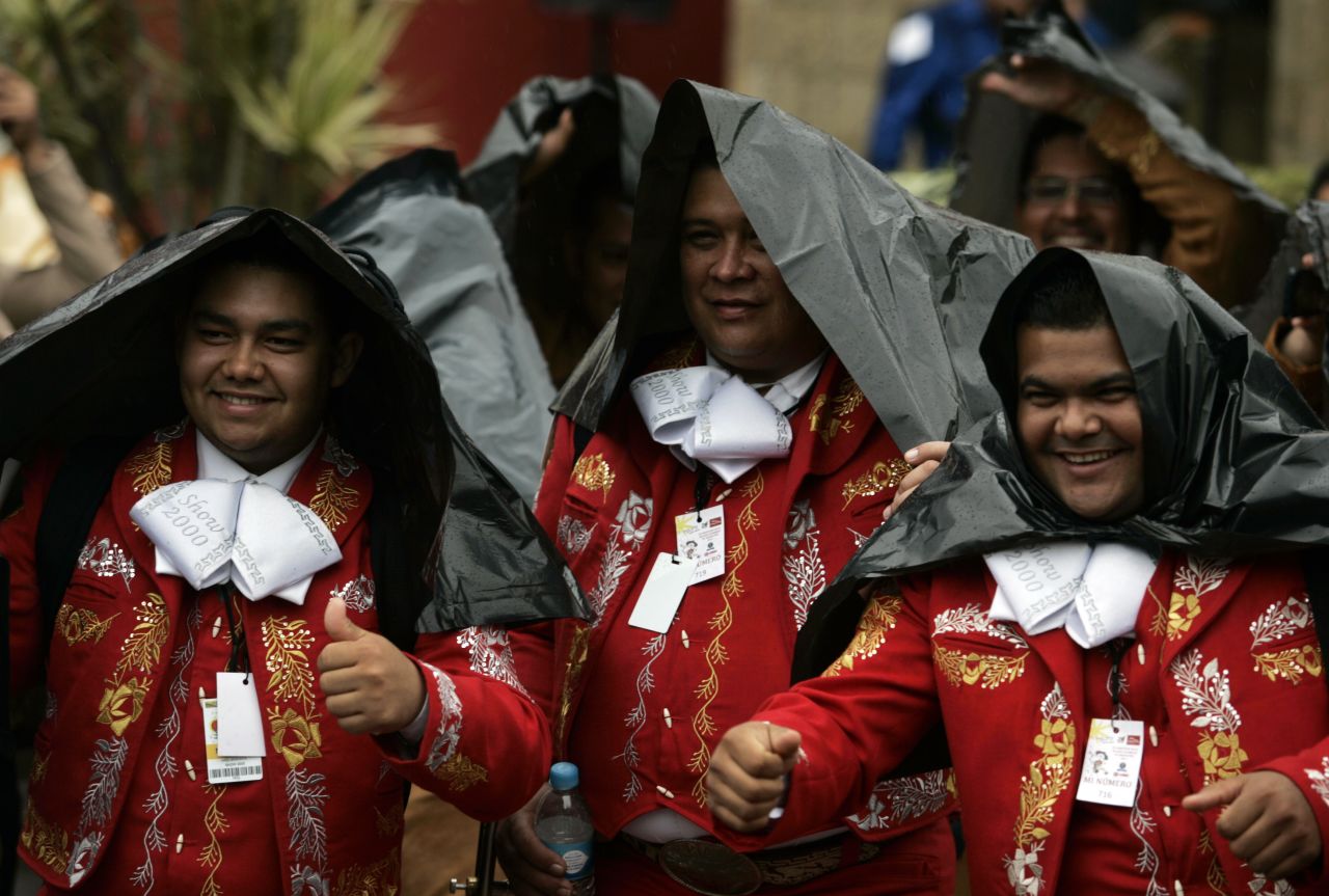 Musicians take cover from the rain before an attempt to break the Guinness World Record for the largest number of mariachis performing the same song, in Guadalajara, Mexico, on September 5. Seven hundred mariachis from various countries, including Mexico, Japan, Colombia and Venezuela, broke the record on Thursday after performing a song for five minutes.