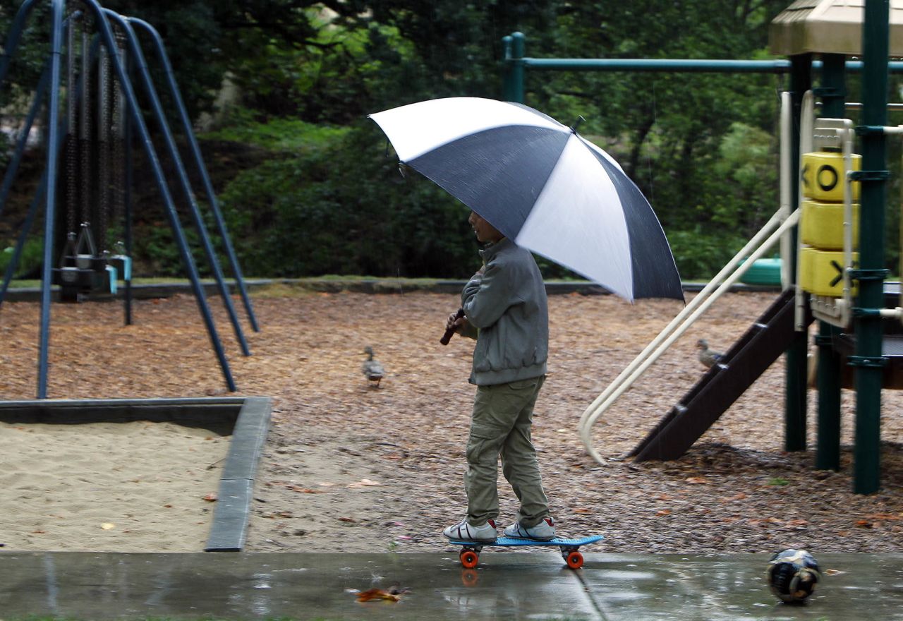 Suhayb Abdul Qader, 11, ignores the rain and plays in Island Park in Springfield, Oregon, on September 5.