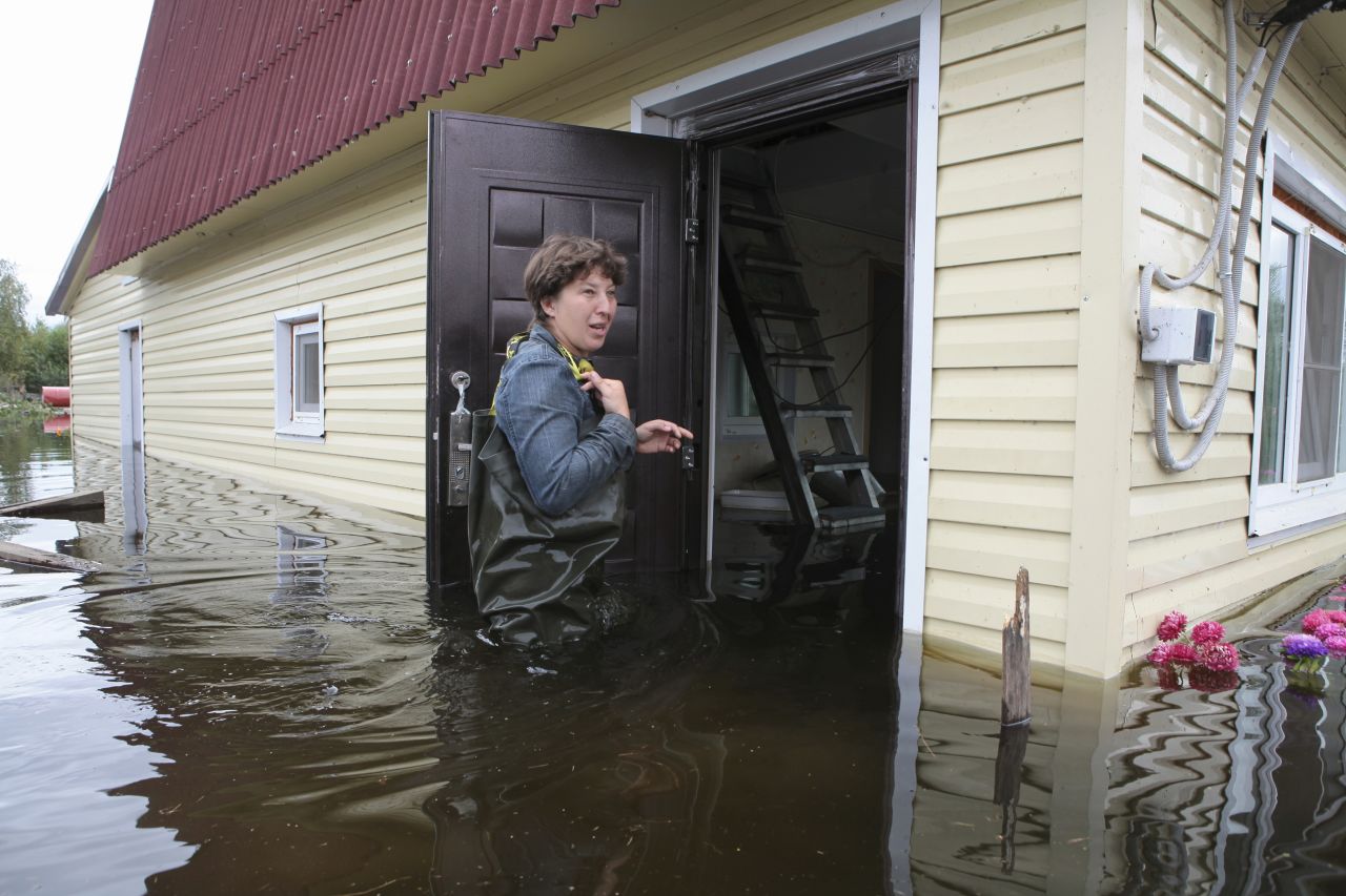 A local resident stands near her country house in a flooded settlement outside Khabarovsk in Russia's far east on September 4.