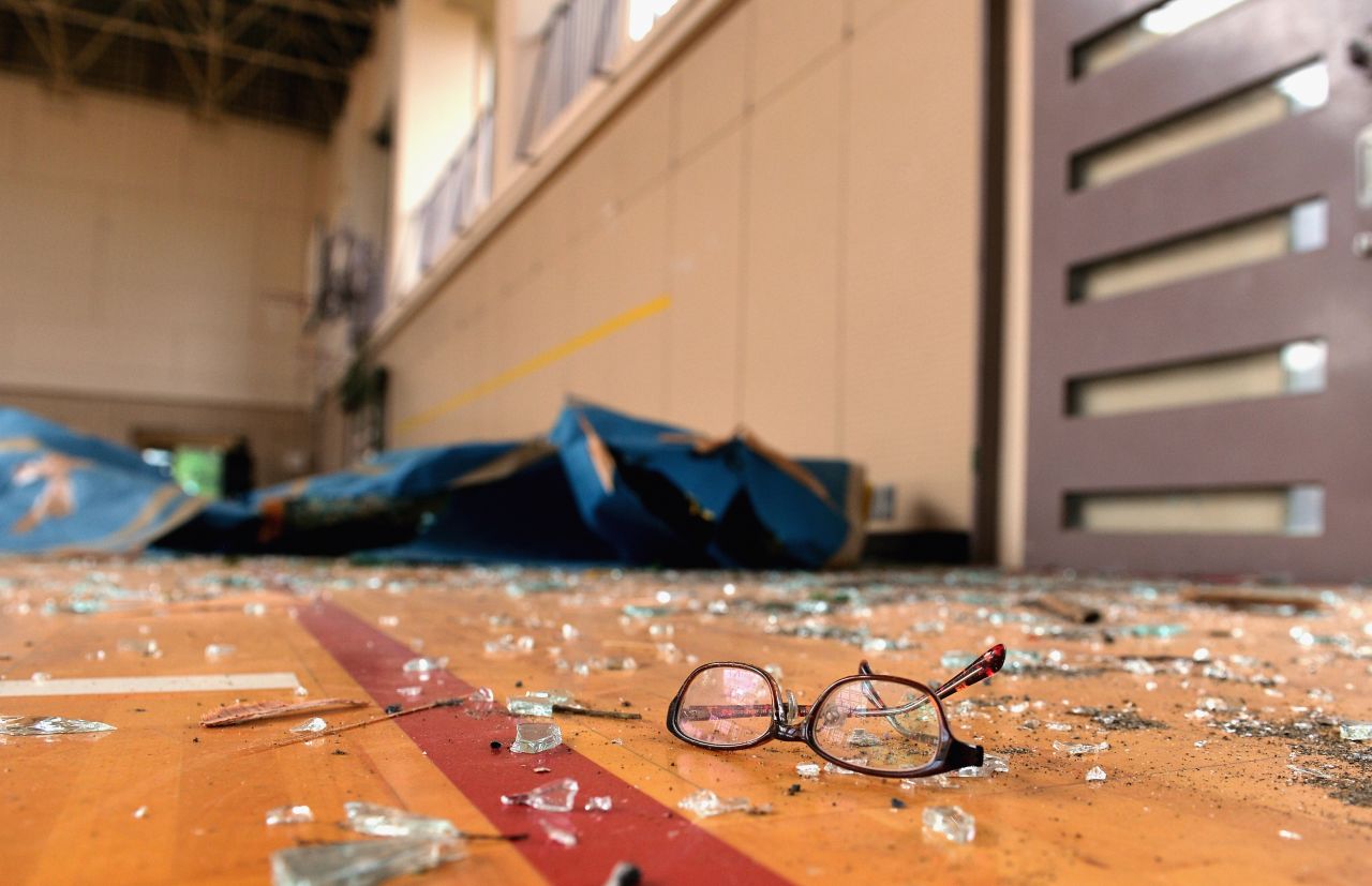 Shattered glass and a pair of spectacles lay in a gymnasium where one student was injured at Hokuyo Junior High School in Koshigaya, Japan, on Monday, September 2. Dozens of people were injured when very strong winds and an apparent tornado struck two cities near Tokyo.