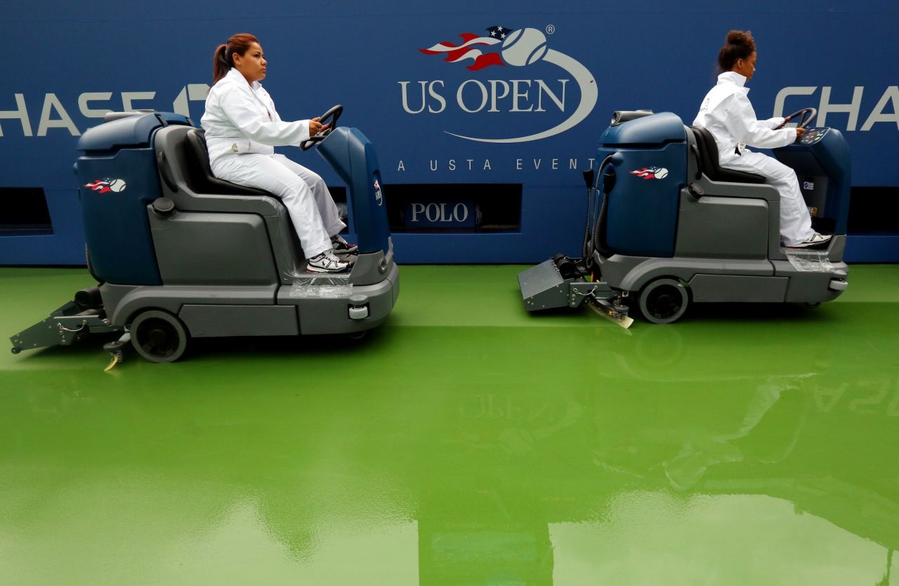 Court attendants dry a tennis court in Arthur Ashe Stadium following a rain delay on day eight of the 2013 U.S. Open at USTA Billie Jean King National Tennis Center in New York on September 2.