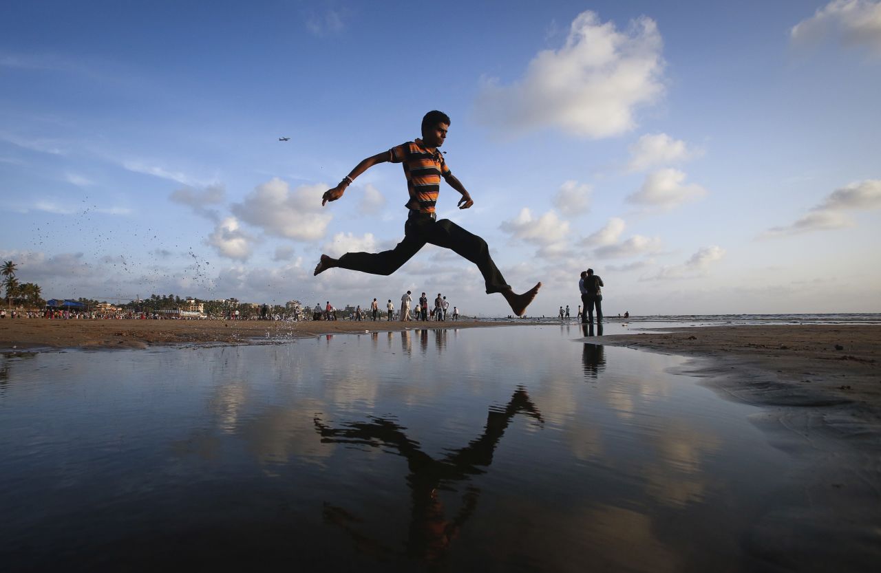 A man jumps over a water stream on a beach along the Arabian Sea in Mumbai, India, on September 2. <a href="http://www.cnn.com/2013/08/28/world/gallery/week-in-weather-0828/index.html">View last week's best weather photos.</a>