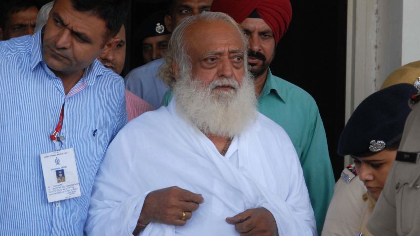 Indian spiritual guru Asaram Bapu (C) is escorted by police, after he was arrested from his Indore ashram, at the airport in Jodhpur on September 1, 2013. Police have arrested the popular Indian spiritual guru for an alleged sexual assault on a 16-year-old schoolgirl at a religious retreat in central India, a local official said.