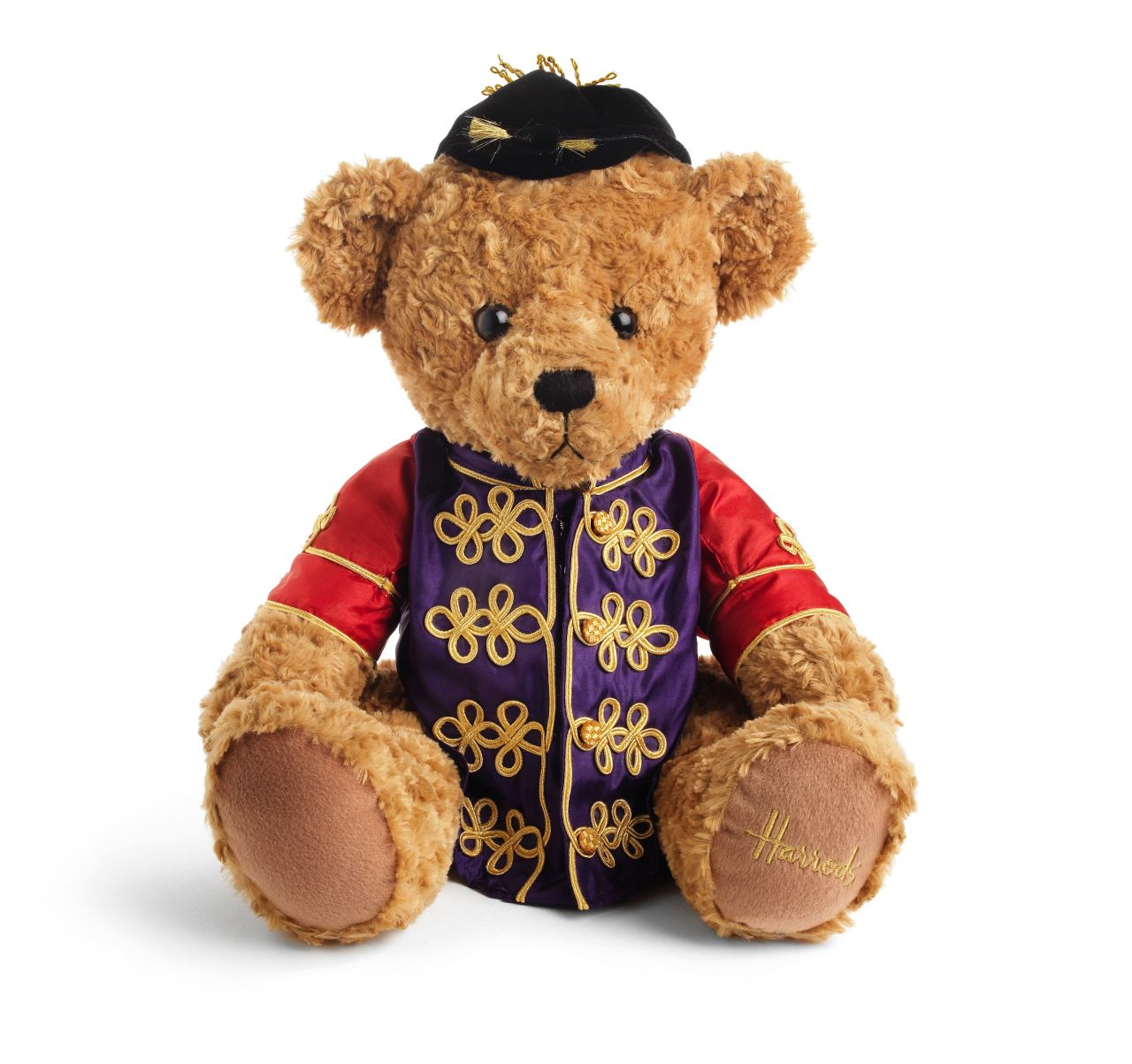 The latest addition to the British royal family, Prince George of Cambridge, was gifted a teddy dressed in the queen's silks, by a leading horse racing organization.   
