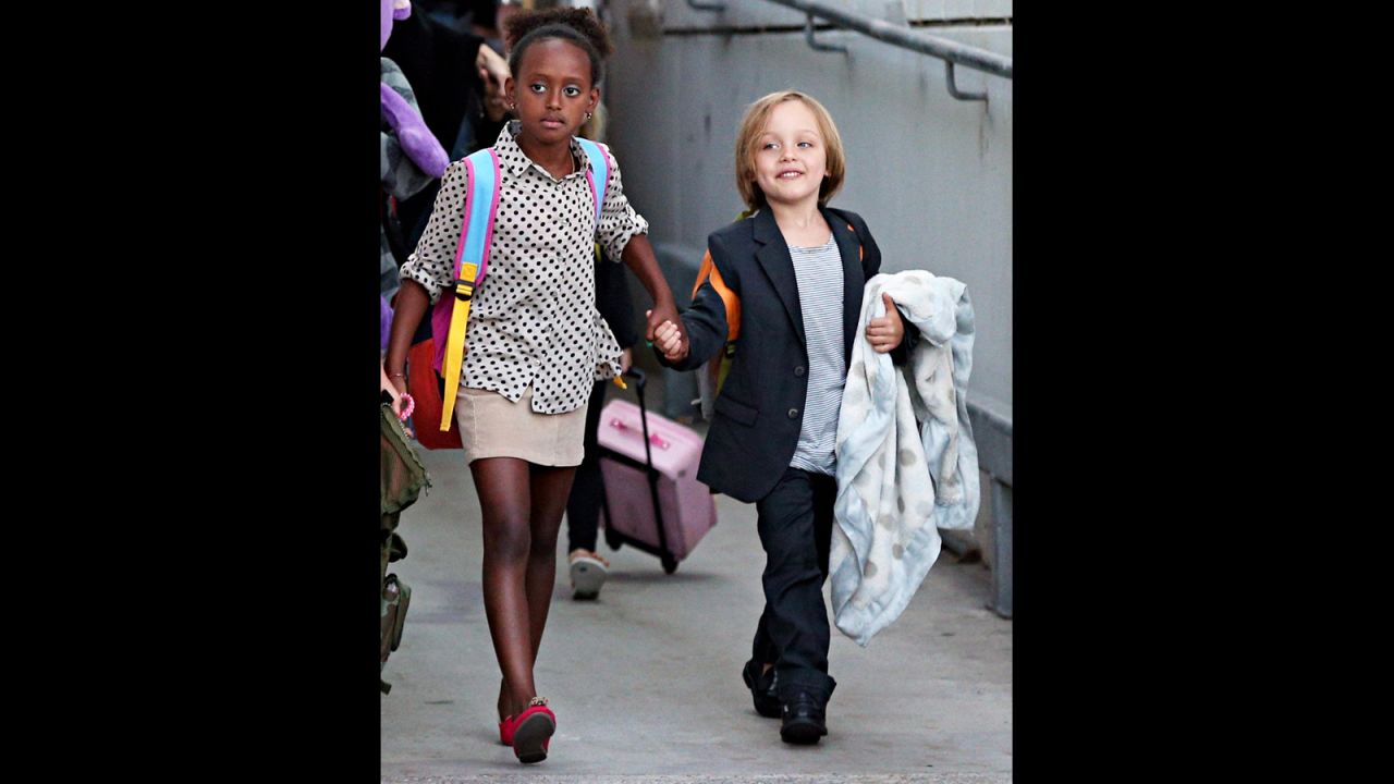 Zahara, now 8, is old enough to help lead her younger siblings through airports.