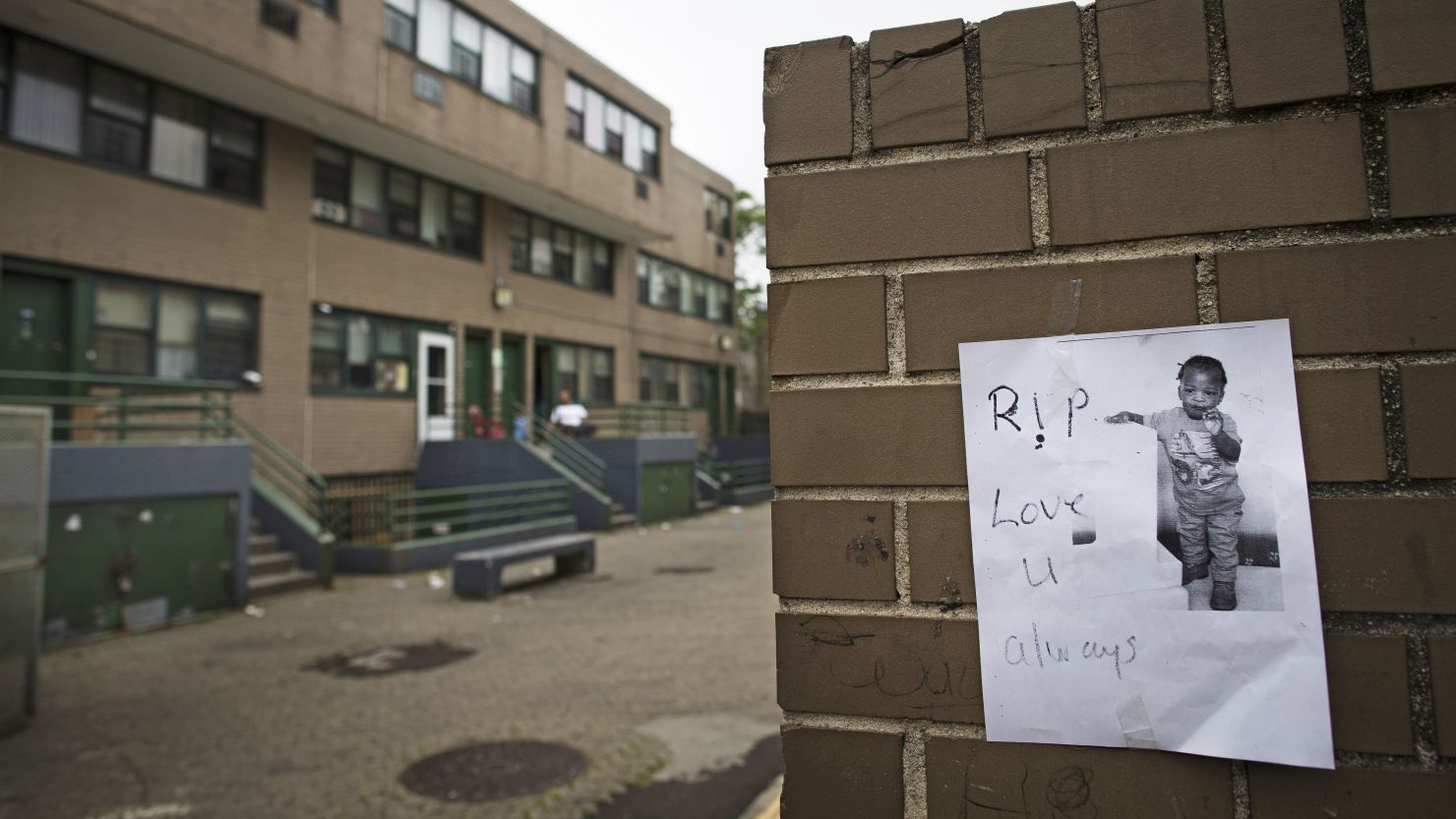 A memorial to Antiq Hennis is posted on a wall outside an apartment complex in the Brownsville neighborhood in Brooklyn.