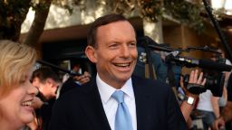 Australian opposition leader Tony Abbott smiles as he leaves a polling station after casting his vote in Sydney on September 7, 2013. Australians began voting in national elections with conservative challenger Tony Abbott heading for a thumping victory over Labor Prime Minister Kevin Rudd.