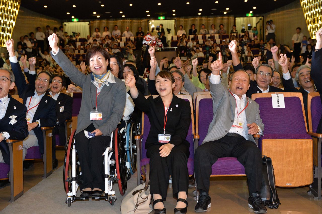 Tokyo joined the ranks of multiple host cities, having staged the sporting showpiece in 1964. Here former Olympic athletes Hiromi Miyake (C) and Yoshiyuki Miyake (R) cheer the announcement back in Japan.