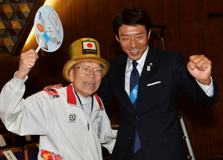 Octogenarian "Olympic superfan" Naotoshi Yamada (L) and former Japanese tennis player Shuzo Matsuoka (R) were among those to cheer the announcement in the early hours in Tokyo. 