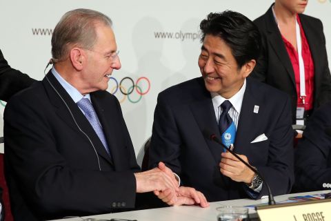 Abe is congratulated by IOC president Jacques Rogge (left) who was standing down after 12 years in the role. The 71-year-old was succeeded by Thomas Bach.
