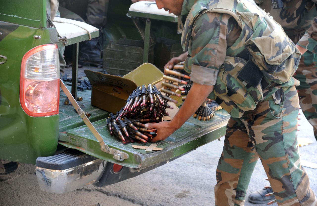 Un soldado sirio prepara balas de grueso calibre para una ametralladora en Maaloula.