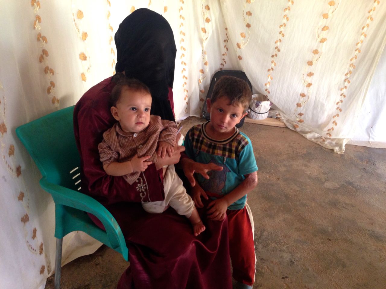 This 22-year-old mother fled Syria with her children four months ago, leaving her husband behind. The burn scars visible on her 4-year-old's arm are the result of an explosion on the streets of her hometown of Homs. Her children are much safer now, but she questions her decision to leave. At the camp, they all sleep on a cement floor, and her 8-month-old son is now so severely malnourished, it's stunting his growth.