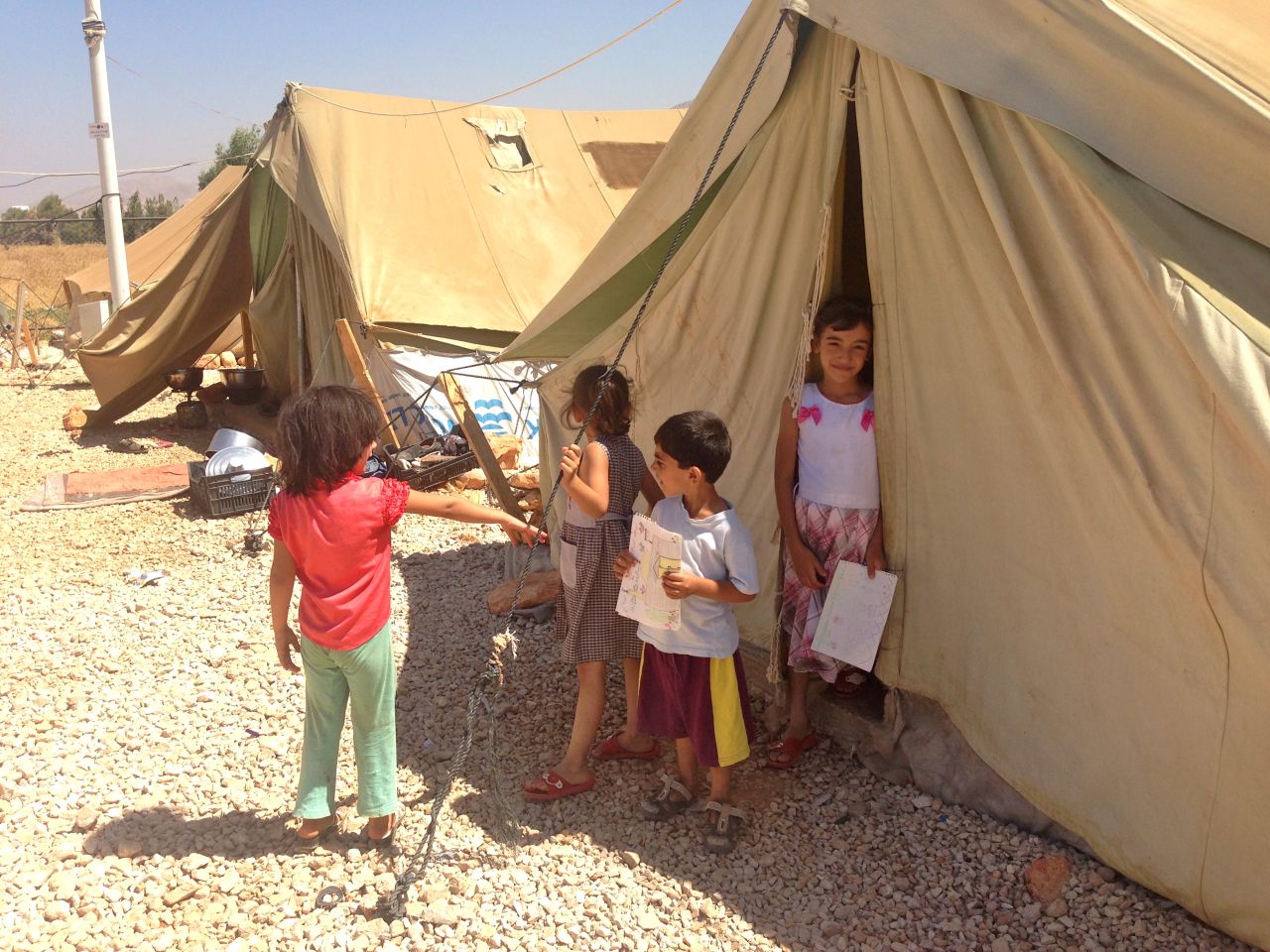 These Syrian children smile, despite the horrors of life in the refugee camp. After fleeing the violence of their home country, refugees say they are not wanted in their adopted one.