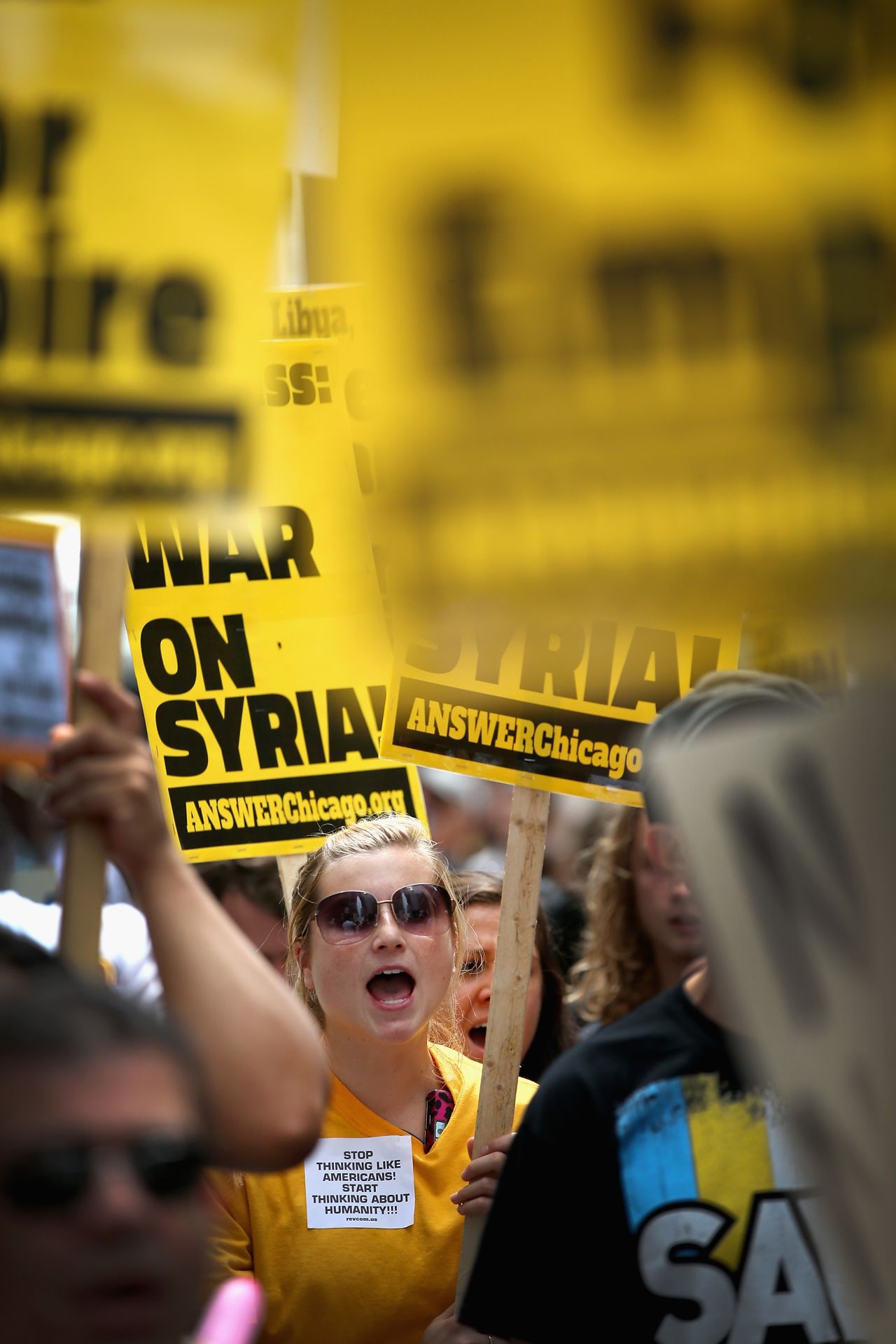 People carry signs to protest U.S. intervention in Syria on September 7 in Chicago.