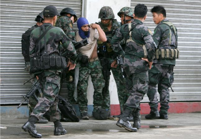 A soldier is helped by comrades after being injured during skirmishes with rebels in Zamboanga City on September 9.