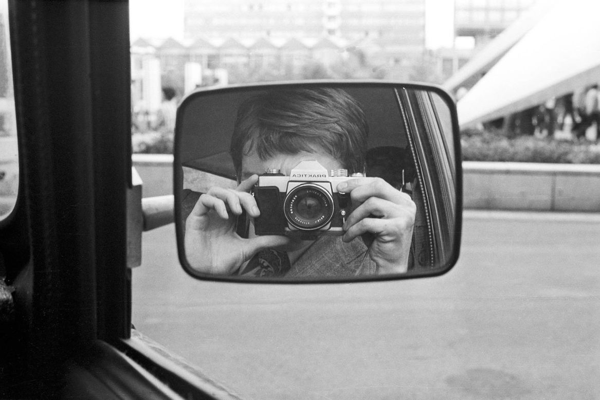 A Stasi agent takes a picture of himself in the car.