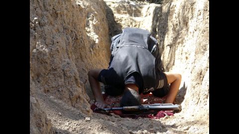 A Free Syrian Army fighter prays in a trench in the Damascus suburbs on September 8.
