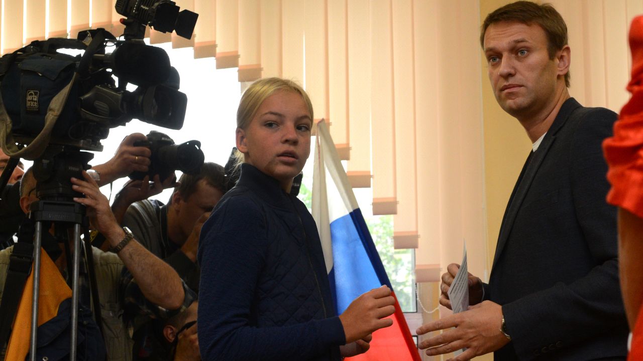 Alexei Navalny prepares to cast his ballot during a mayoral election in Moscow, on September 8, 2013, with his daughter, Dasha.