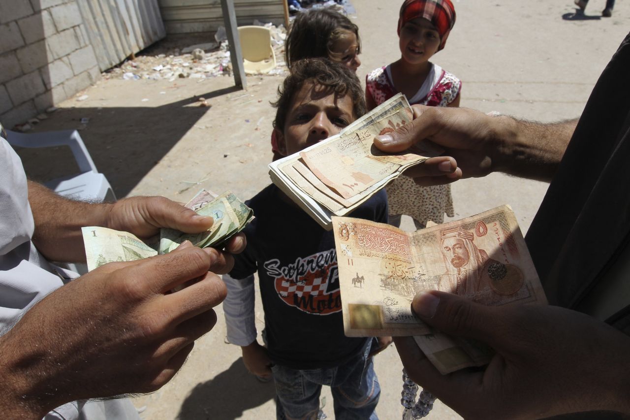 A refugee money-changer exchanges currency at the main market at the Zaatari refugee camp near Mafraq in September 2013.