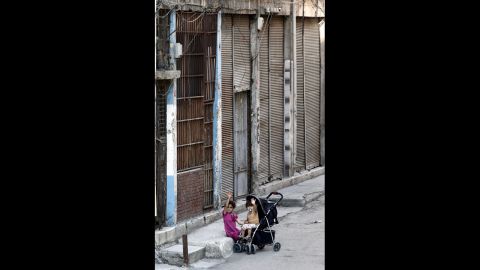Two Syrian refugee children sit outside a house in Istanbul in September 2013.