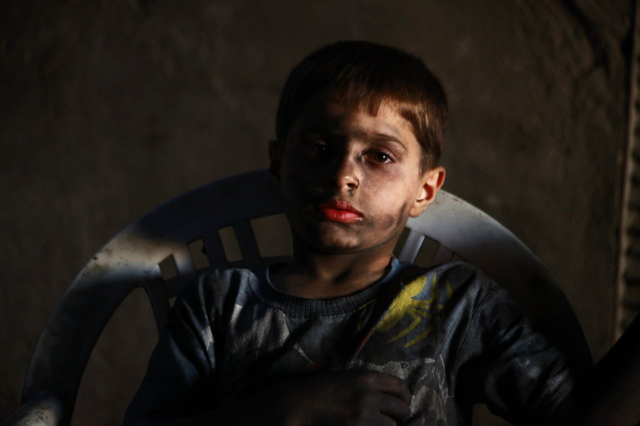 Issa poses for a picture while resting in the weapons factory.