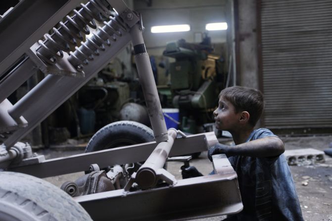 Issa fixes a mortar launcher in a Free Syrian Army weapons factory in Aleppo.