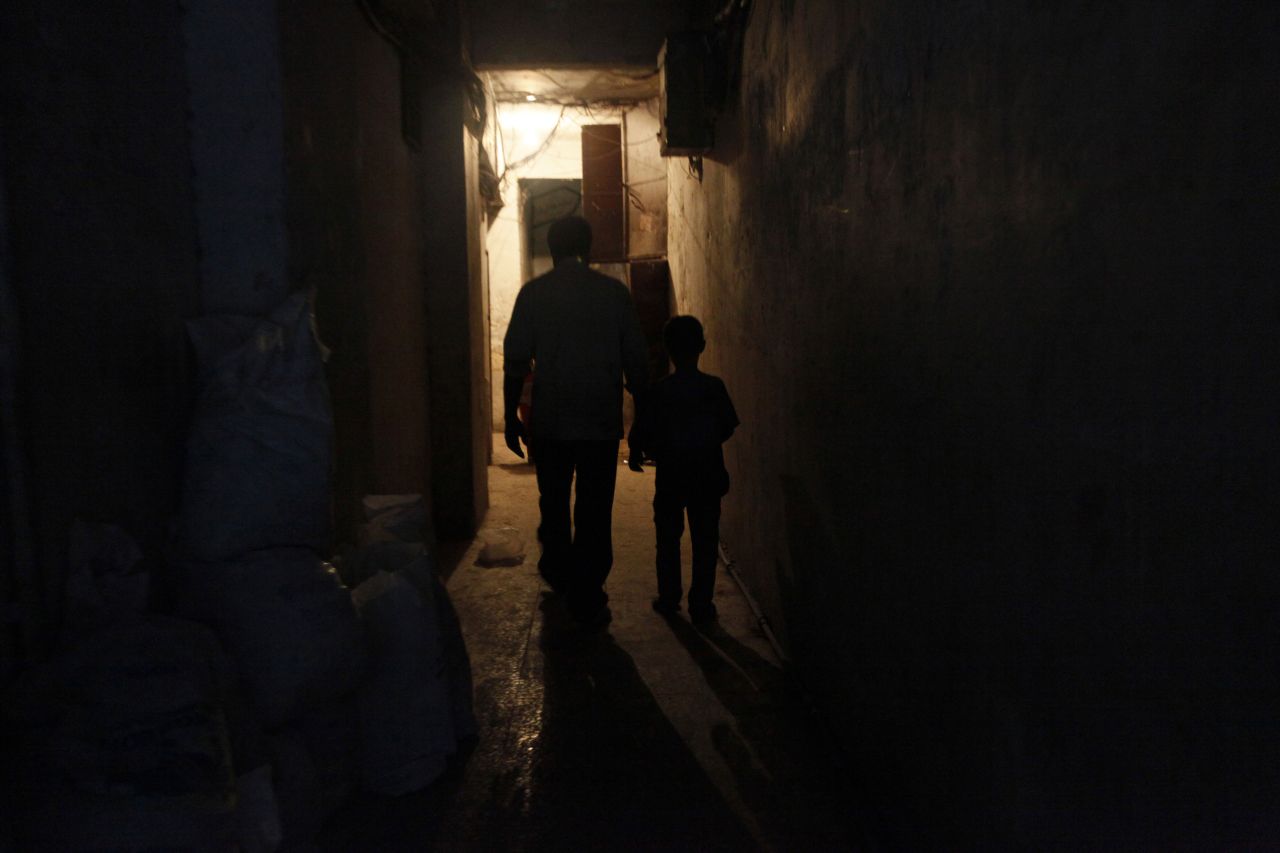 Issa returns home with his father after a long day working in the weapons factory.