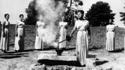22nd September 1964: During the ancient ceremony at Olympia, Greek actress Aleca Katseli, lights the Olympic Torch which will be carried to Tokyo, the site of the 1964 Olympic Games, by a relay of runners.